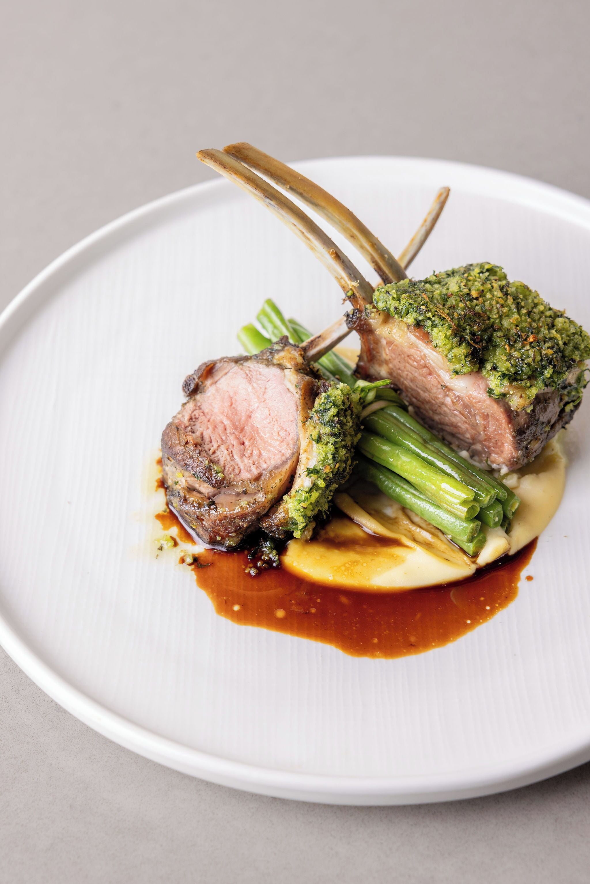 A plate with a dish of meat, vegetables, and sauce.