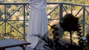 A person in a white dress standing on a balcony overlooking a mountainous landscape. - Hotel & terme Bagni di Lucca (Bagni di Lucca)