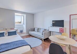 Classic Studio, River View | Living area | Flat-screen TV