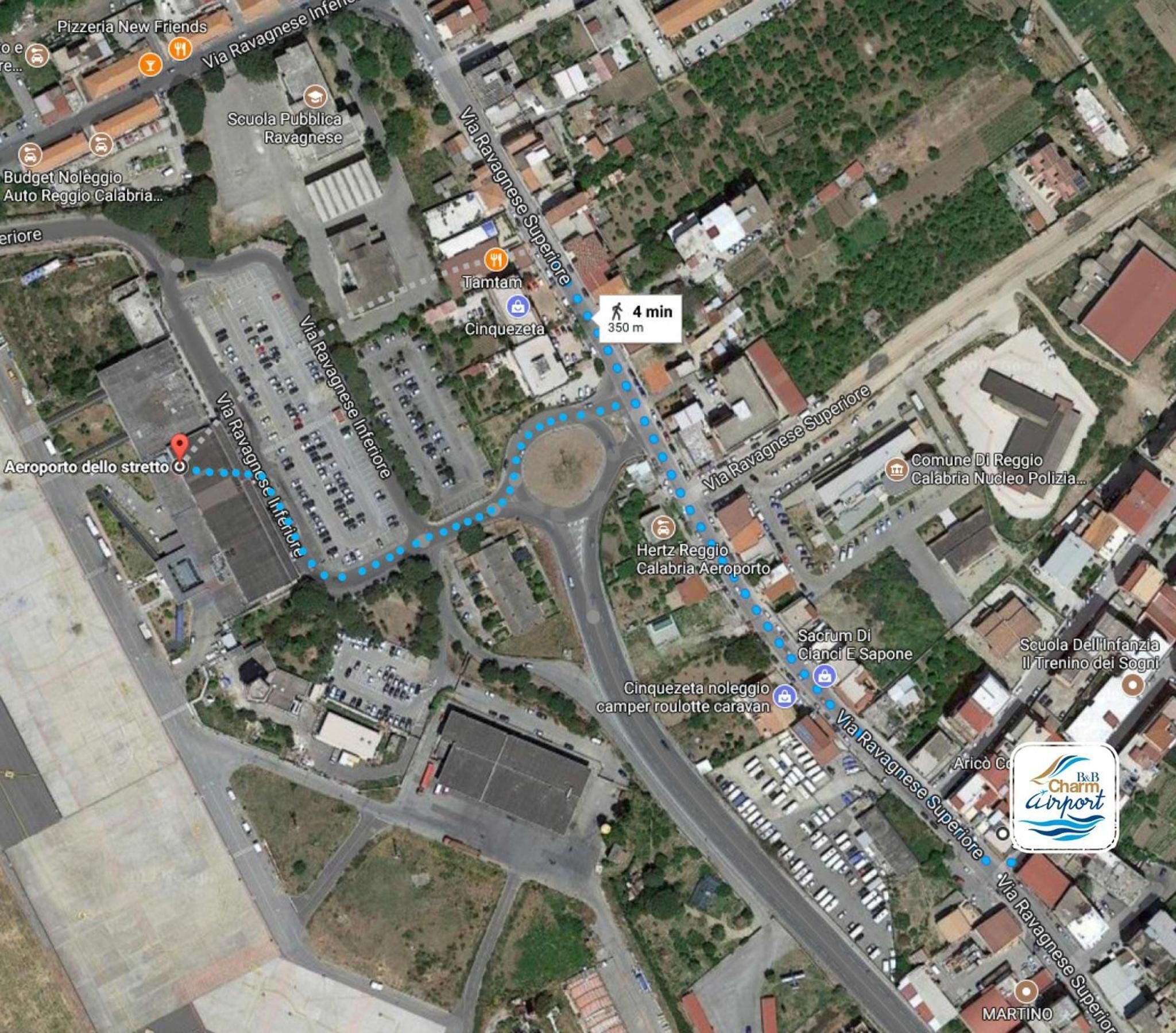 An aerial view of a city with a prominent airport, marked locations, and various buildings.