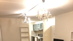 A living room with a sectional sofa, a coffee table, a TV on a stand, and a kitchen in the background. - Guest House Centrum 3 (Oslo)