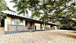 A building with a tiled patio area, a covered seating area, and a fenced garden. - St Lucia Palms (St. Lucia)