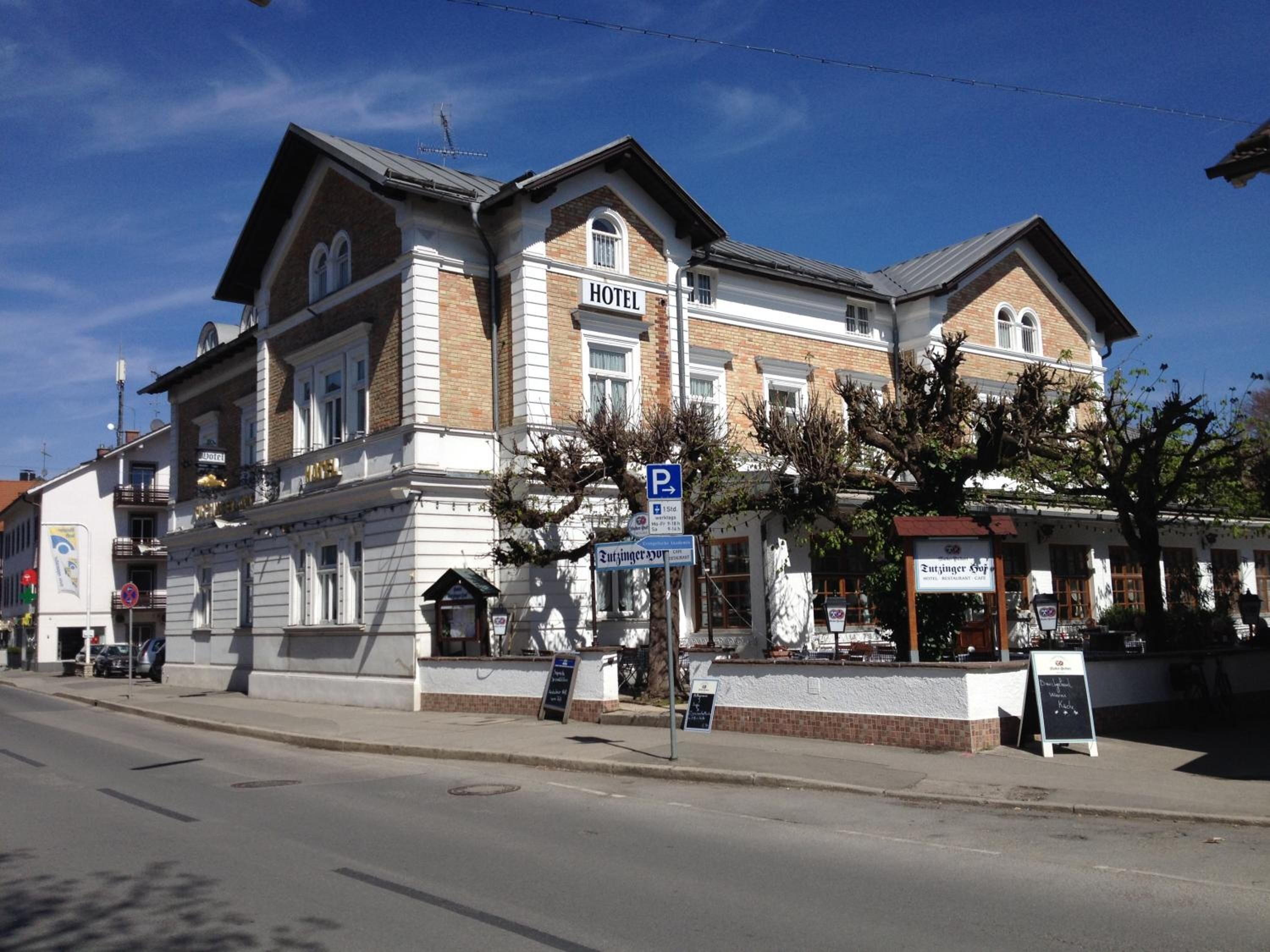 A hotel with a classic architectural style, featuring a prominent entrance and a signboard.