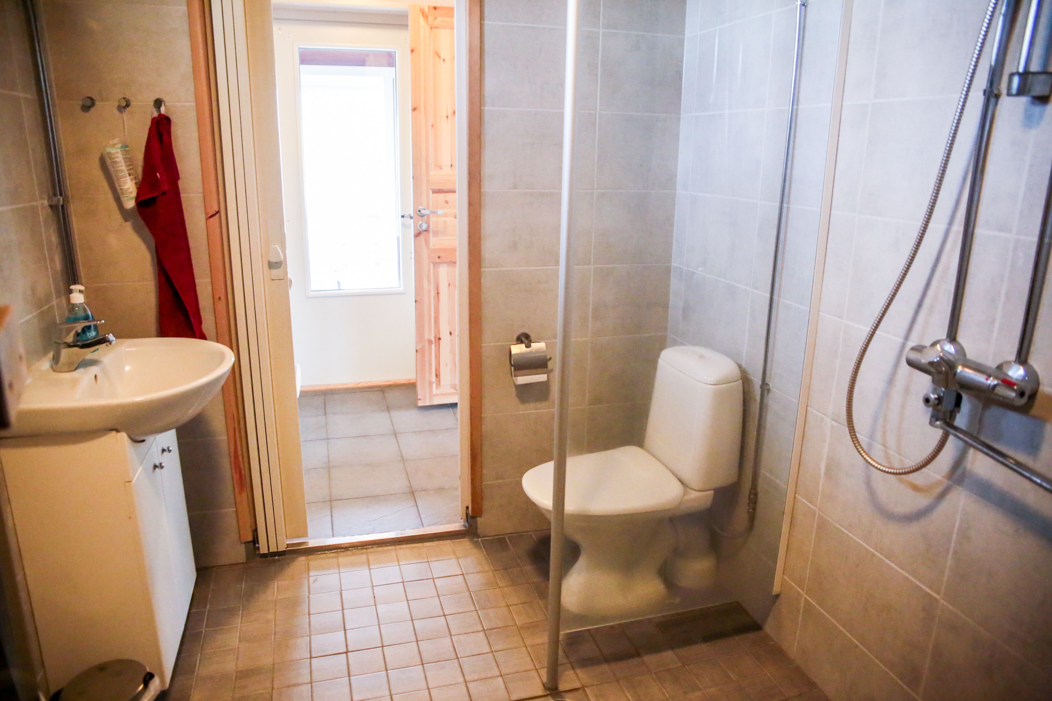 A bathroom with a sink, toilet, and shower.