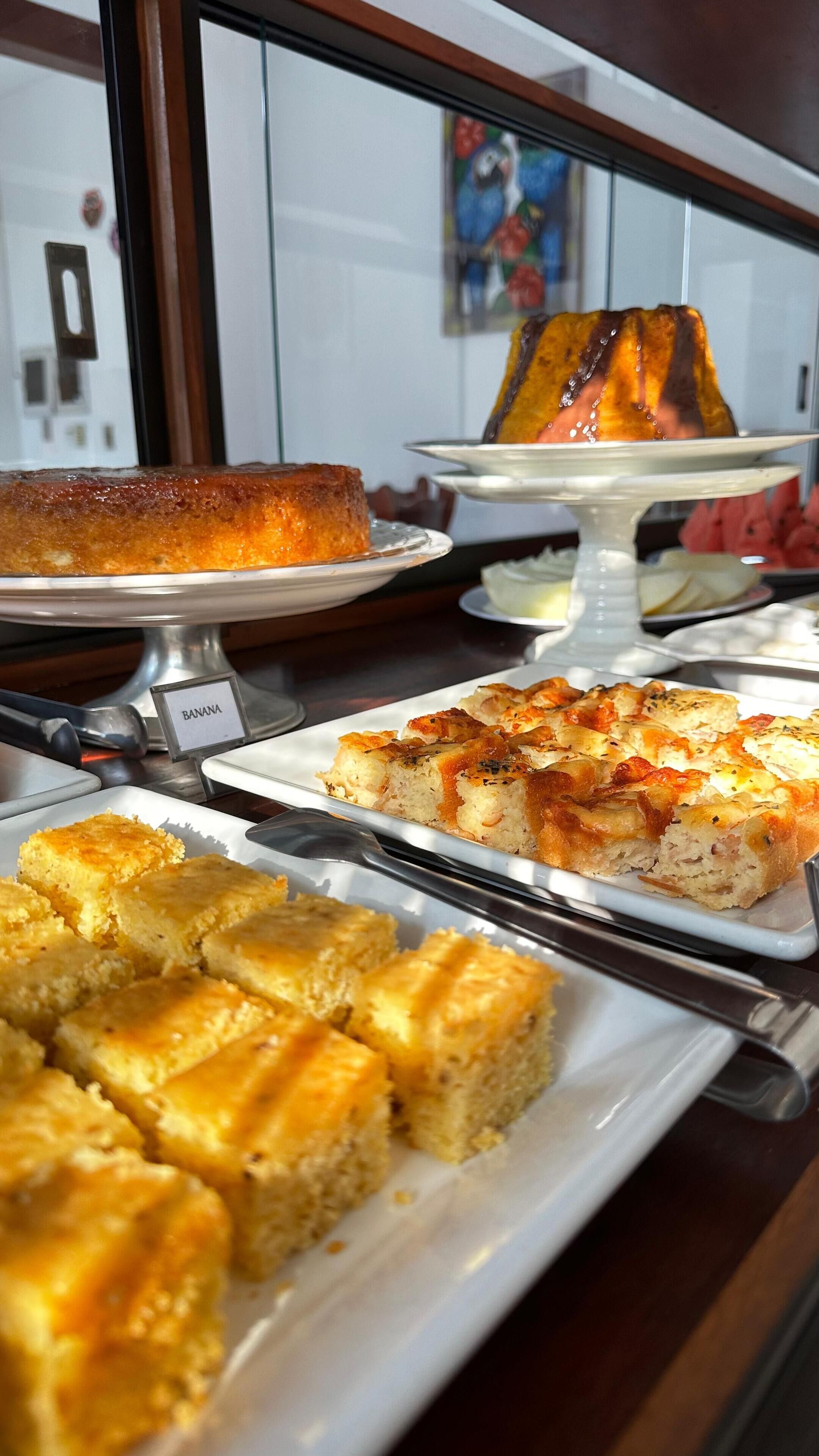 A dessert display with various cakes and pastries.