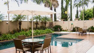 Outdoor pool, open 7:00 AM to 10:00 PM, pool loungers