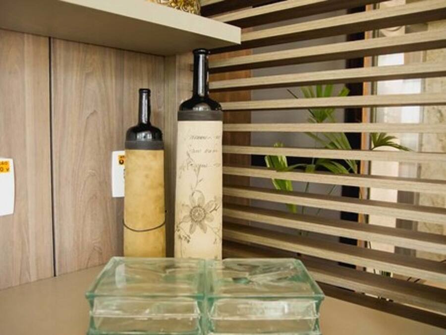 A wine display with bottles and a wooden slatted shelf.