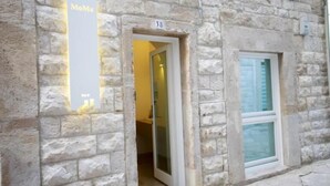 A stone building with a sign reading "MoMa" and a number "38" above a doorway. - MoMa Molfetta Mare (Molfetta)