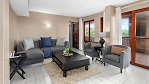 A modern living room with a grey sofa, a coffee table, and a side table with a lamp. - San Lameer Villa Rentals 2826 (Southbroom)