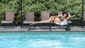 A poolside area with lounge chairs and a pool. - San Lameer Villa Rentals 3501 (Southbroom)