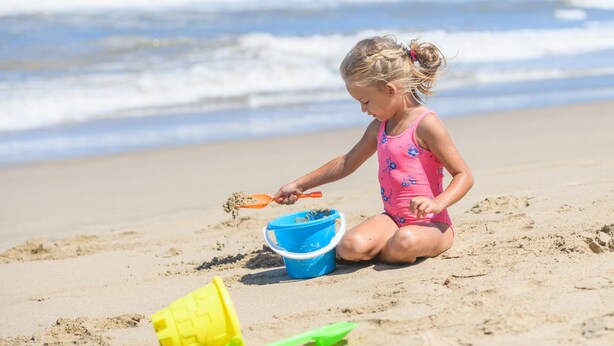 A child playing with sand on a beach. - San Lameer Villa Rentals  2301 (Southbroom)