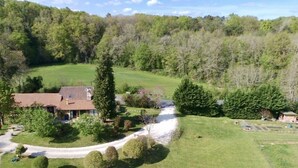 A rural house with a tiled roof, surrounded by a well-maintained lawn and trees. - Les Filolies (Saint-Andre-d'Allas)