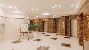 A spacious lobby with a marble floor, a potted plant, and an information board. - Toyoko Inn Cebu (Mandaue)