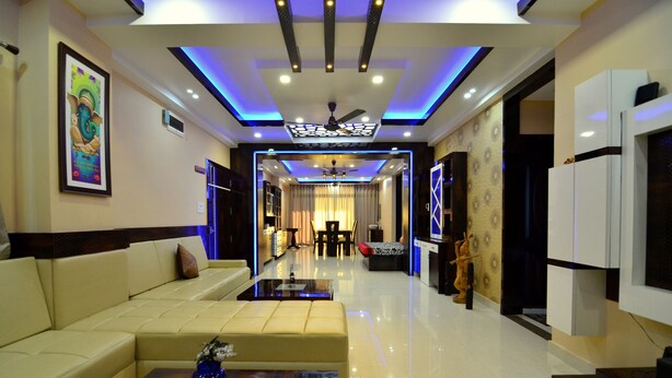 A modern living room with a sofa, coffee table, and decorative items. - Tulip Residency (Dibrugarh)