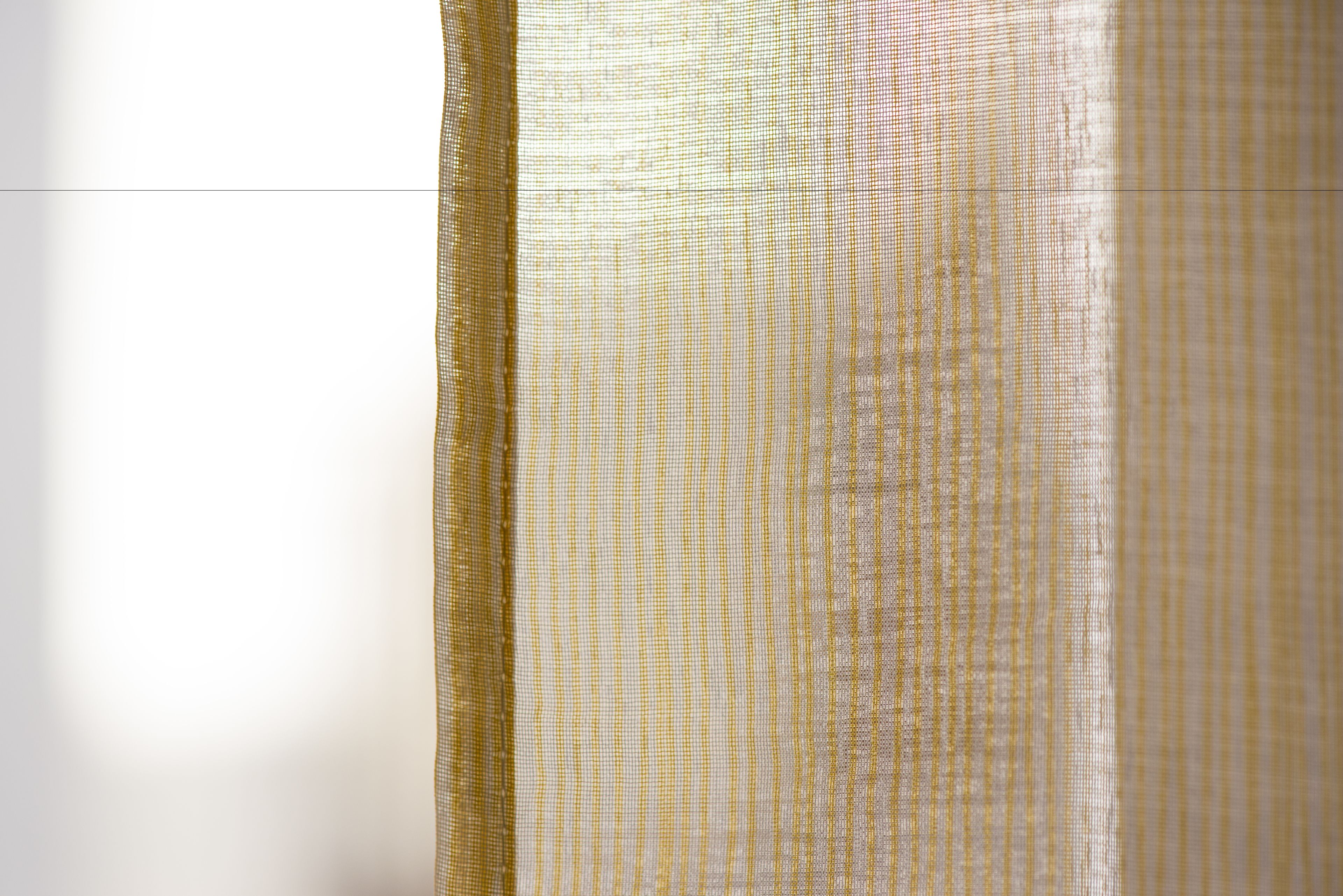 A close-up of a fabric with a diagonal striped pattern.