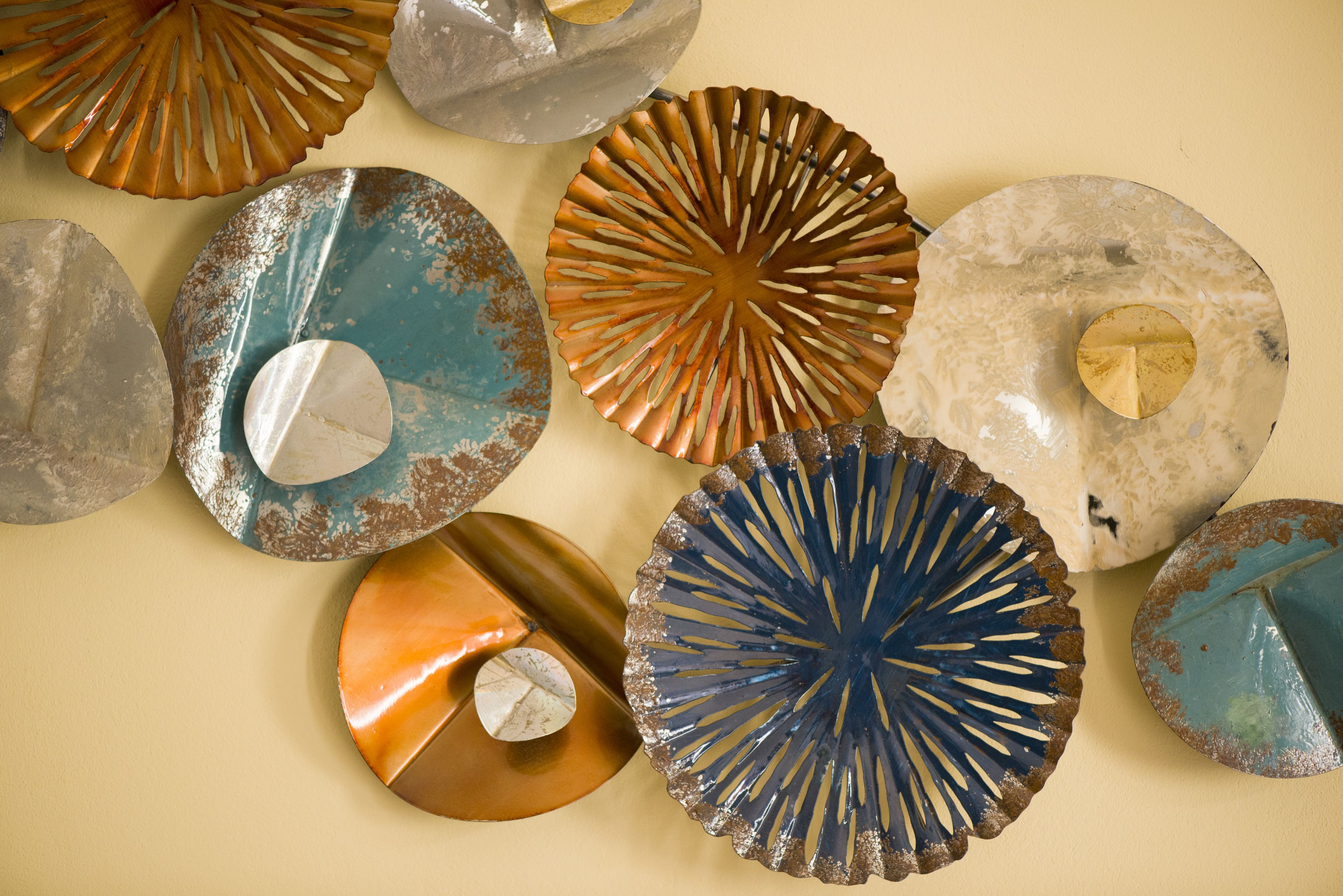 A collection of circular decorative plates with various textures and designs.