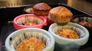 A tray with several muffin cups containing muffins.