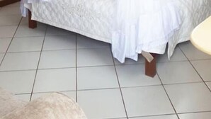 A bed with a canopy, a wooden wardrobe, and a nightstand. - Sagas Hotel Ltd (Nairobi)