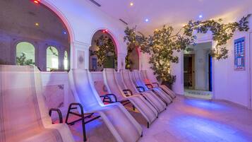 Relax in a serene spa area with massage chairs, a lush plant, and a tranquil atmosphere.