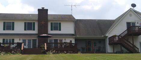 A two-story house with a chimney, a balcony, and a garage.