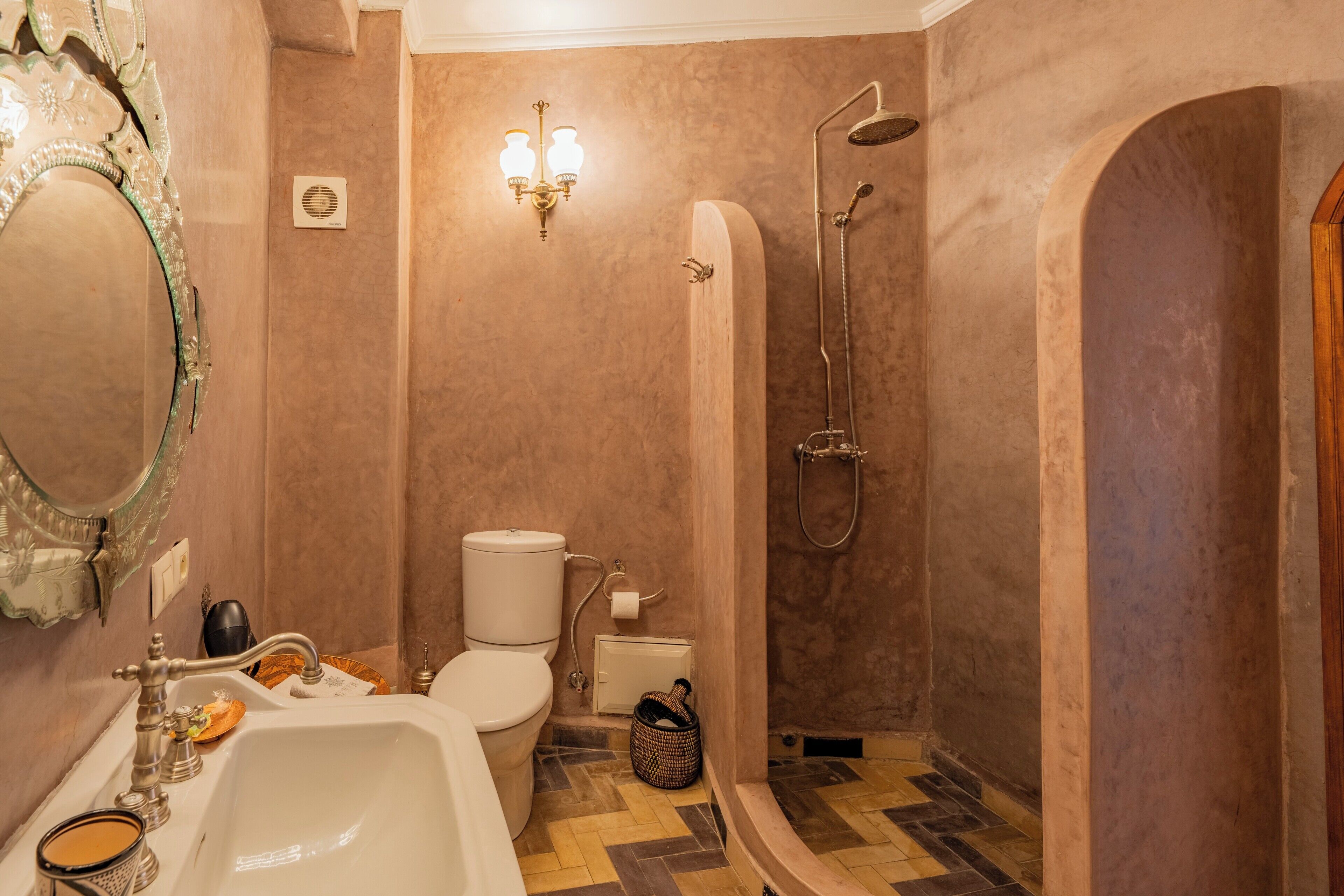 A bathroom with a sink, toilet, and shower.
