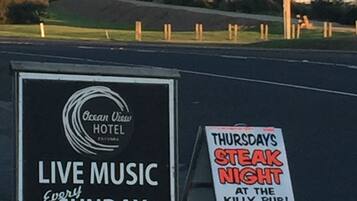 A sign for Ocean View Hotel advertising live music every Sunday afternoon.