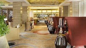 A hotel lobby with a bar area, seating arrangements, and a decorative ceiling. - Easeland Hotel  Guangzhou (Guangzhou)