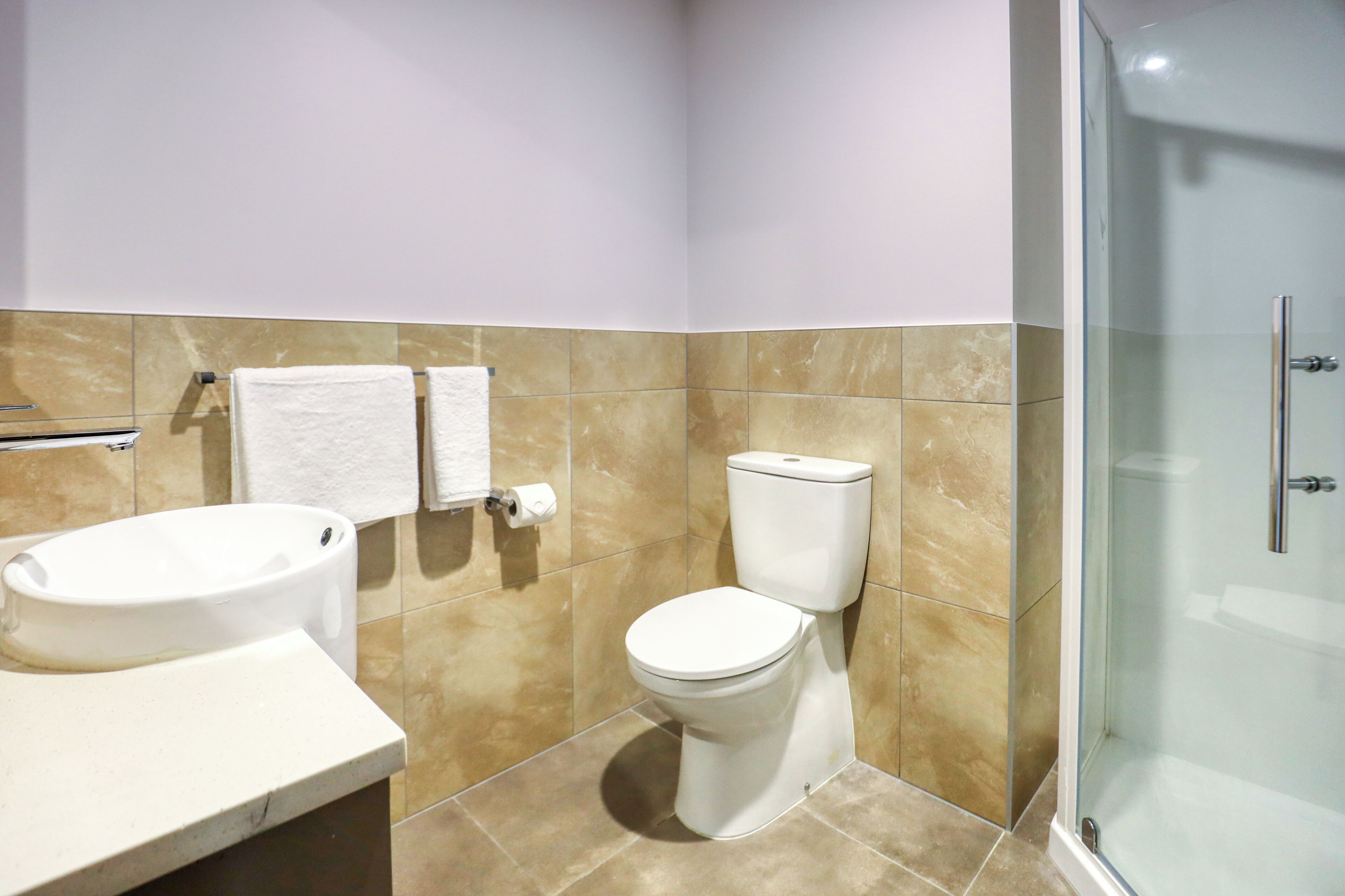 superior studio suite | bathroom | shower, eco-friendly toiletries, hair dryer, towels