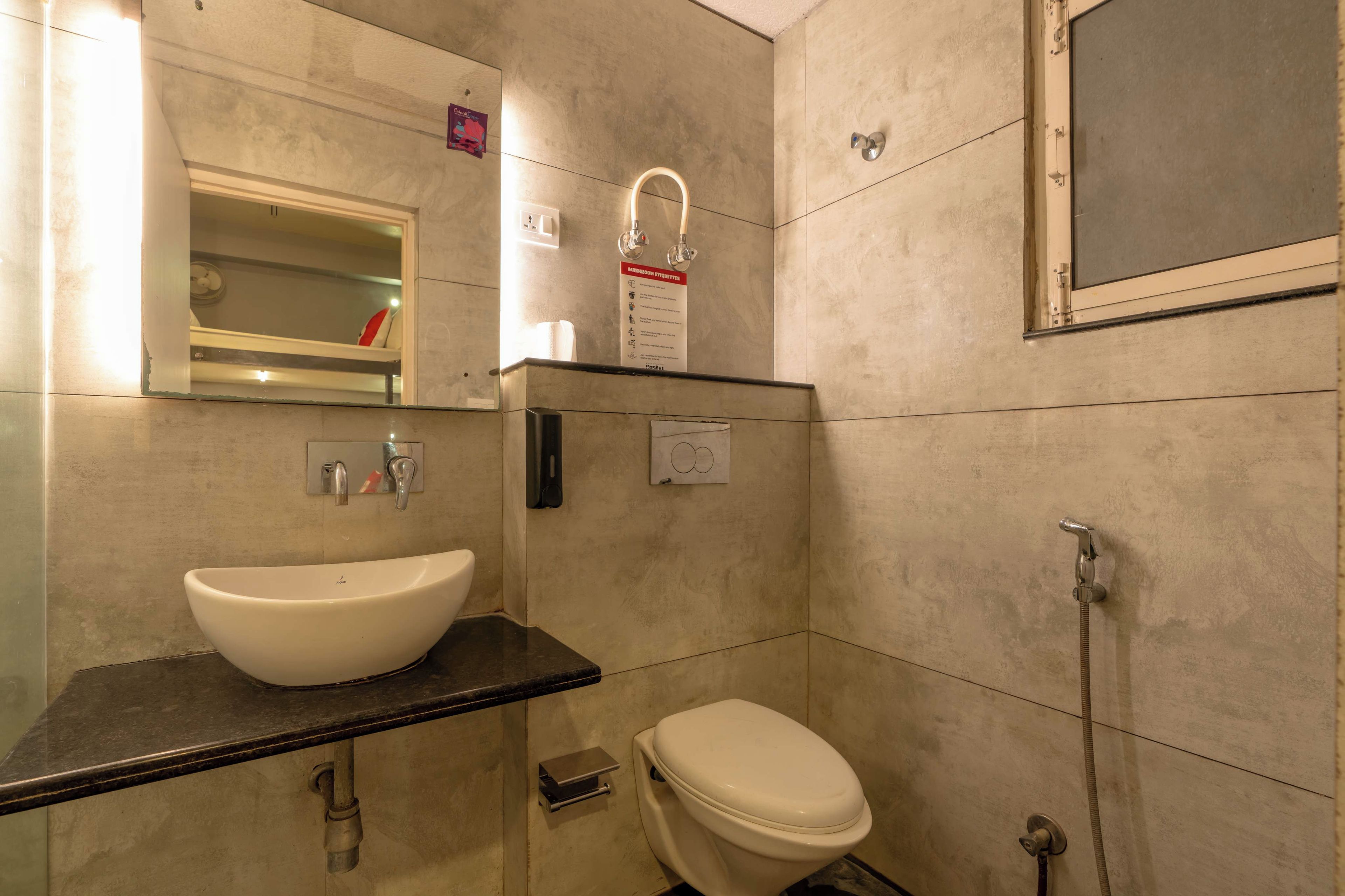 A bathroom with a white sink, a toilet, and a shower.