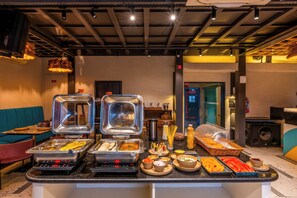 A buffet area with various food options and seating arrangements. - Moustache Jaipur (Jaipur)
