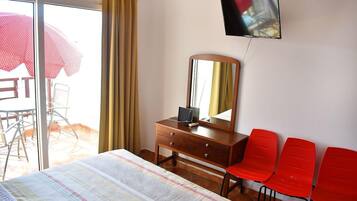 Desk, iron/ironing board, bed sheets