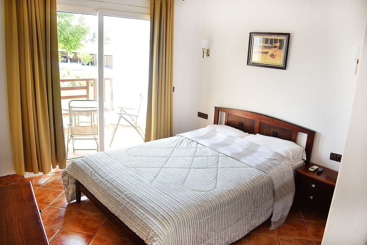 Desk, iron/ironing board, bed sheets