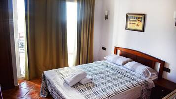 Desk, iron/ironing board, bed sheets