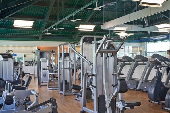 A gym with various exercise machines, treadmills, and free weights. - Bourbon Barra da Tijuca Residence (RIO DE JANEIRO)