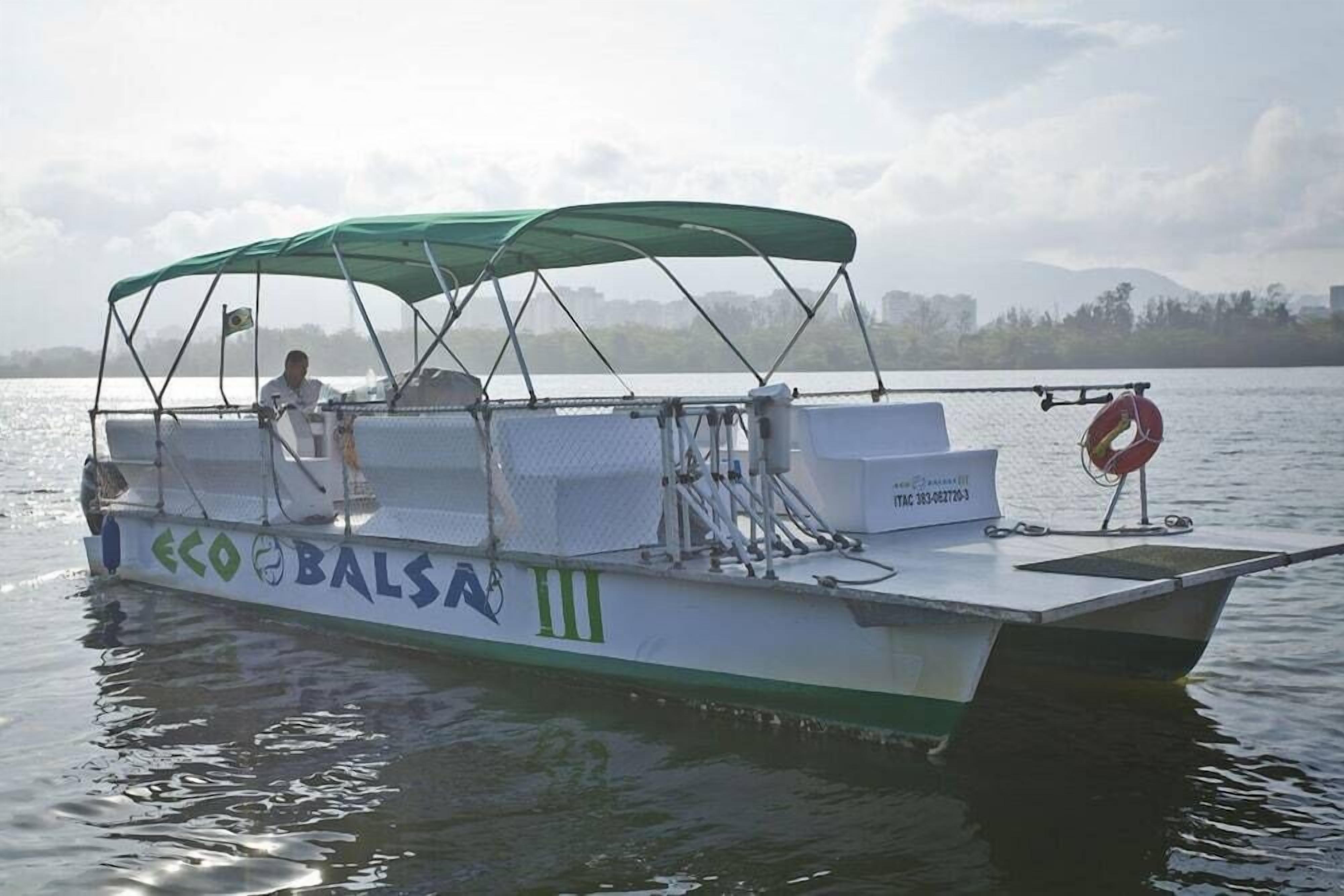A boat with a green canopy, labeled "ECO BALSAN," on a body of water.