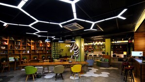 A modern interior with hexagonal floor tiles, wooden furniture, and a central table with chairs.