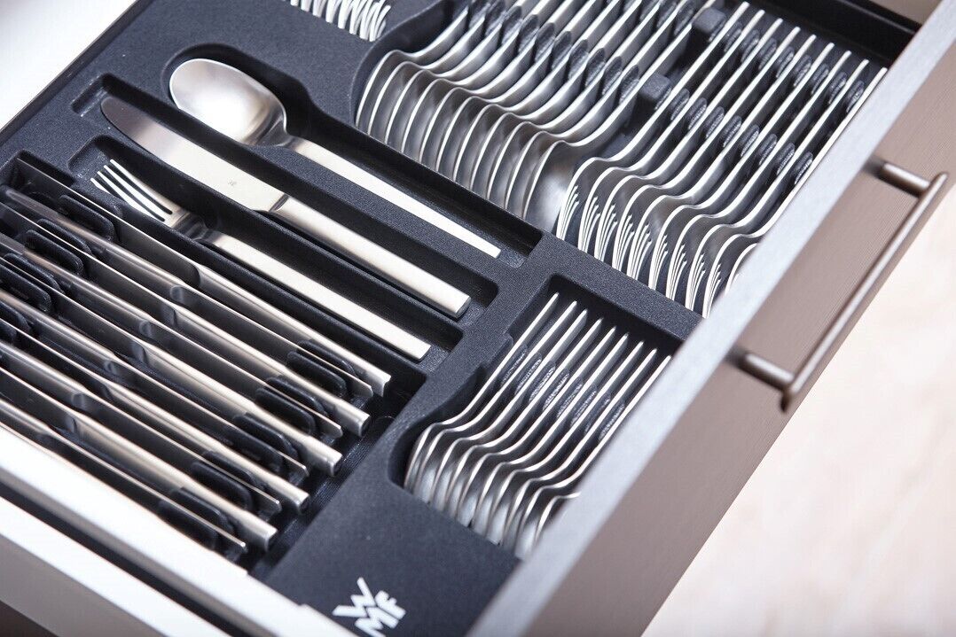 A drawer with compartments for utensils and cutlery.