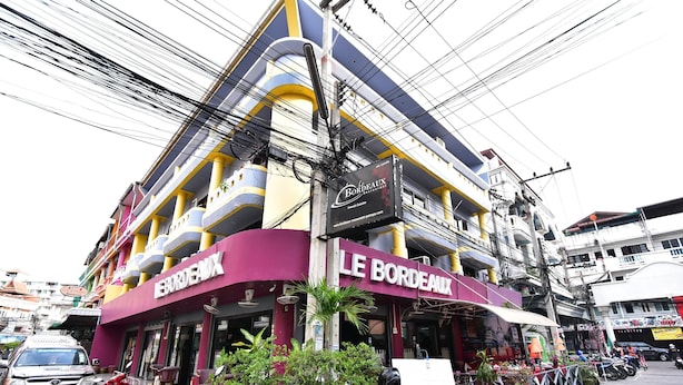 A multi-story building with a prominent 'Bordeaux' sign, indicating a restaurant or bar. - DE Apartment (Pattaya)