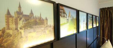 A wall with framed pictures of various buildings.