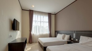 A hotel room with two beds, a TV mounted on the wall, and a large window with curtains. - Kesang Laut Hotel (Muar)