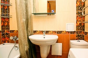 Economy appartement | Badkamer | Een bad/douchecombinatie, gratis toiletartikelen, een haardroger
