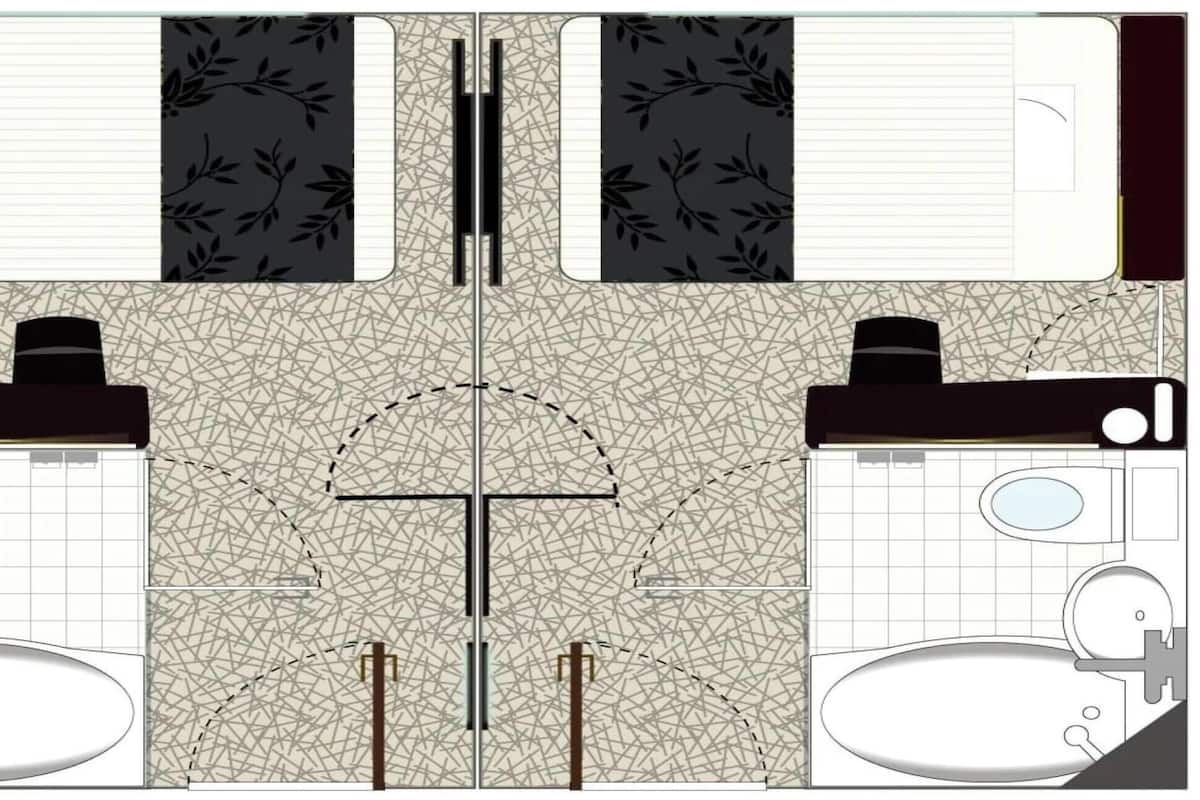 A bathroom layout with two sinks, two toilets, and a shower area.