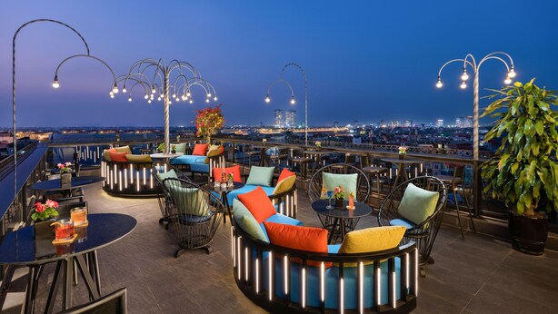 A rooftop terrace with round seating areas, tables, and street lamps. - Shining Central Hotel & Spa (Hanoi)