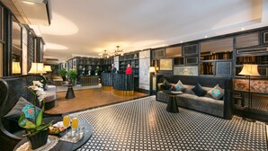 A modern lobby with a reception desk, seating area, and a patterned floor. - Shining Central Hotel & Spa (Hanoi)