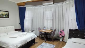 Standard Triple Room | Desk, blackout drapes, soundproofing, iron/ironing board