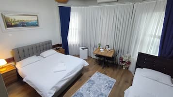 Standard Triple Room | Desk, blackout drapes, soundproofing, iron/ironing board
