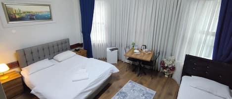 Standard Triple Room | Desk, blackout drapes, soundproofing, iron/ironing board
