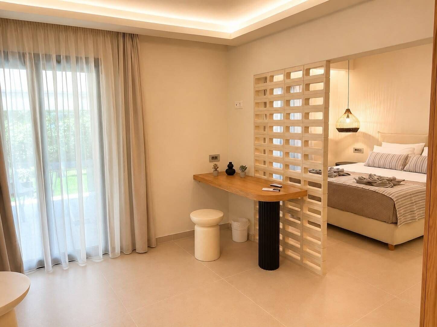 A modern bedroom with a bed, bedside table, and a window with curtains.