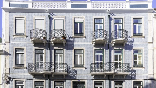 A multi-story building with balconies, each with ornate wrought iron railings. - 1898 Home & Suites (Lisbon)