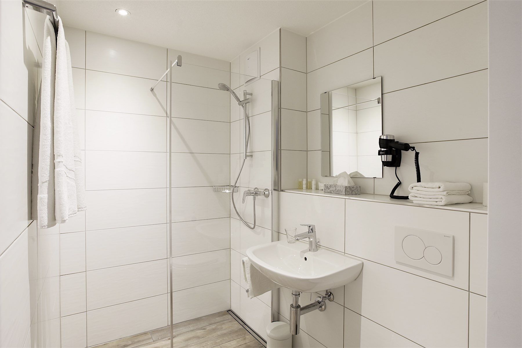 shower, hair dryer, towels, shampoo